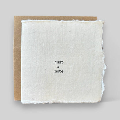 Small white handmade typewritten just a note card